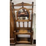 19TH CENTURY OAK MIRROR BACK HALL STAND WITH LIFT-UP LID ON SQUARE SUPPORTS.