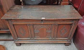 18TH / 19TH CENTURY OAK COFFER WITH DECORATIVE CARVED PANEL FRONT ON BLOCK FEET