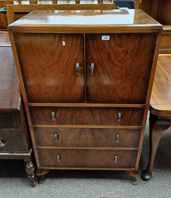 MID 20TH CENTURY WALNUT CABINET WITH 2 PANEL DOORS OVER 3 DRAWERS ON SHORT QUEEN ANNE SUPPORTS.