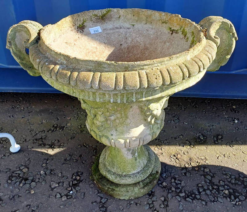 RECONSTITUTED STONE GARDEN URN ON CIRCULAR PLINTH BASE.