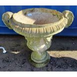 RECONSTITUTED STONE GARDEN URN ON CIRCULAR PLINTH BASE.