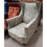 19TH CENTURY OAK FRAMED WINGBACK ARMCHAIR WITH GREEN FLORAL PATTERN