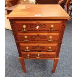 SMALL OAK CHEST WITH CARVED DECORATION & 4 DRAWERS WITH BRASS HANDLES ON SQUARE TAPERED SUPPORTS.