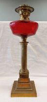 BRASS CORINTHIAN COLUMN PARAFFIN LAMP WITH CRANBERRY GLASS RESERVOIR