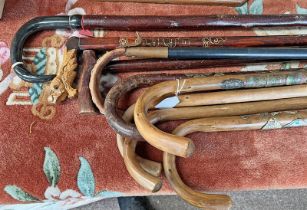 GOOD SELECTION OF WALKING STICKS INCLUDING 2 WITH VARIOUS BADGES, CARVED WOOD HANDLED STICK, ETC,