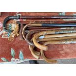 GOOD SELECTION OF WALKING STICKS INCLUDING 2 WITH VARIOUS BADGES, CARVED WOOD HANDLED STICK, ETC,