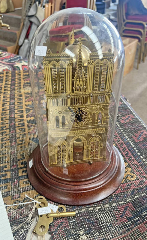 GILT METAL MANTLE CLOCK IN THE FORM OF A BUILDING WITH PIERCED FEATURES TO BOTH SIDES IN A GLASS