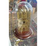 GILT METAL MANTLE CLOCK IN THE FORM OF A BUILDING WITH PIERCED FEATURES TO BOTH SIDES IN A GLASS