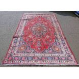 RED GROUND PERSIAN MARSHAD CARPET WITH CENTRAL MEDALLION FLORAL PATTERN - 310 X 205CM