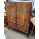 20TH CENTURY ROSEWOOD CABINET WITH 2 PANEL DOORS OVER 2 BRUSHING SLIDES OVER 4 DRAWERS ON SQUARE