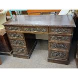 19TH CENTURY CARVED OAK KNEEHOLE DESK WITH CENTRALLY SET SINGLE LONG DRAWER FLANKED BY 2 STACKS OF