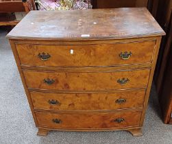 20TH CENTURY CROSSBANDED WALNUT BOW FRONT CHEST OF 4 DRAWERS ON BRACKET SUPPORTS.