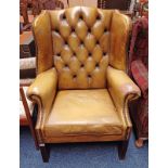 GREEN LEATHER BUTTONED WINGBACK ARMCHAIR ON SQUARE MAHOGANY SUPPORTS