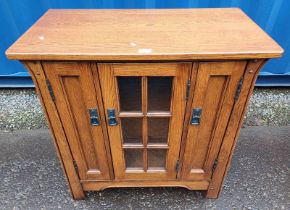 OAK MEDIA CABINET WITH CENTRALLY GLAZED PANEL DOORS FLANKED TO EACH SIDE BY NARROW PANEL DOOR
