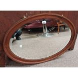 20TH CENTURY INLAID MAHOGANY FRAMED OVAL MIRROR WITH BEVELLED EDGE.