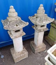 PAIR OF RECONSTITUTED STONE ORIENTAL TOWER GARDEN ORNAMENTS ON SQUARE PLINTH BASES.