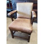 EARLY 20TH CENTURY OAK FRAMED GENTLEMAN'S ARMCHAIR WITH BROWN LEATHER UPHOLSTERY ON BLOCK FEET WITH