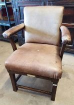 EARLY 20TH CENTURY OAK FRAMED GENTLEMAN'S ARMCHAIR WITH BROWN LEATHER UPHOLSTERY ON BLOCK FEET WITH