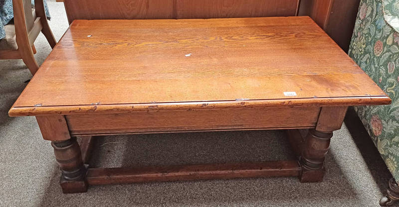 OAK RECTANGULAR COFFEE TABLE WITH SLIDING TOP OPENING TO STORAGE SPACE ON TURNED SUPPORTS,