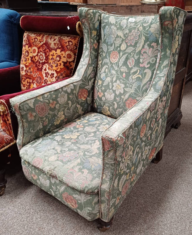 19TH CENTURY OAK FRAMED WINGBACK ARMCHAIR WITH GREEN FLORAL PATTERN