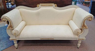 WHITE & GILT SCROLL ARM SETTEE WITH SHAPED BACK ON DECORATIVE REEDED SUPPORTS