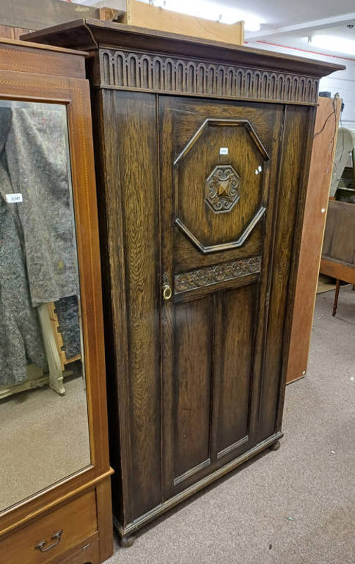 EARLY 20TH CENTURY OAK SINGLE DOOR WARDROBE WITH CARVED DECORATION LABELLED JENNER'S PRINCES STREET,