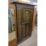 EARLY 20TH CENTURY OAK SINGLE DOOR WARDROBE WITH CARVED DECORATION LABELLED JENNER'S PRINCES STREET,