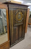 EARLY 20TH CENTURY OAK SINGLE DOOR WARDROBE WITH CARVED DECORATION LABELLED JENNER'S PRINCES STREET,