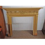 PINE FIRE SURROUND WITH DENTIL CORNICE & CARVED DECORATION.