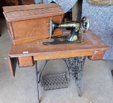 OAK SINGER SEWING TABLE WITH CASED SEWING MACHINE ON CAST IRON TREADLE MACHINE NO G81549