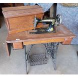 OAK SINGER SEWING TABLE WITH CASED SEWING MACHINE ON CAST IRON TREADLE MACHINE NO G81549