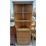 ERCOL ELM CORNER CABINET WITH OPEN SHELVES OVER SINGLE PANEL DOOR.