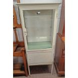 EARLY 20TH CENTURY PAINTED METAL MEDICINE CABINET WITH GLAZED PANEL DOOR OPENING TO SHELVED