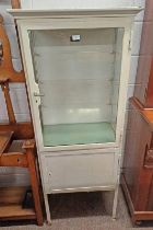 EARLY 20TH CENTURY PAINTED METAL MEDICINE CABINET WITH GLAZED PANEL DOOR OPENING TO SHELVED