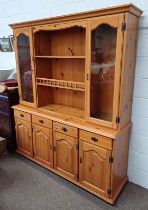 PINE DRESSER WITH SHELF BACK WITH 2 GLAZED PANEL DOORS OVER BASE WITH 4 DRAWERS OVER 4 PANEL DOORS,
