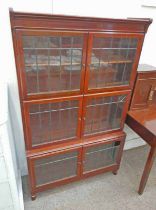 MAHOGANY BOOKCASE WITH SHELVED INTERIOR BEHIND 4 LEADED GLASS PANEL DOORS OVER BASE WITH 2 LEADED