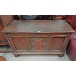 18TH / 19TH CENTURY OAK COFFER WITH DECORATIVE CARVED PANEL FRONT ON BLOCK FEET