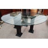 LARGE GLASS TOPPED CIRCULAR TABLE ON PAINTED BASE WITH 4 REEDED SQUARE COLUMNS ON PLINTH BASES.