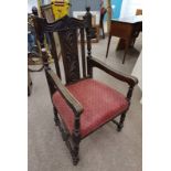 19TH CENTURY OAK OPEN ARMCHAIR WITH DECORATIVE CARVED BACK ON TURNED SUPPORTS