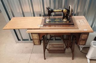 MAHOGANY JONES SEWING TABLE WITH FOLD-OUT MACHINE & 4 DRAWERS ON CAST IRON TREADLE MACHINE NO