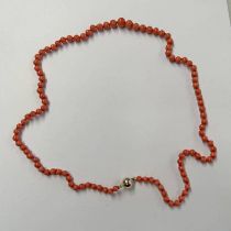 CORAL BEAD NECKLACE WITH CLASP MARKED 585 .
