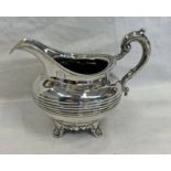 VICTORIAN SILVER CREAM JUG WITH RIBBED DECORATION ON 4 SHAPED SUPPORTS BY A & J SAVORY,