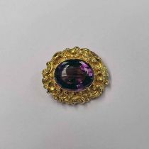 19TH CENTURY YELLOW METAL SCROLL WORK BROOCH INSET WITH FACETED OVAL AMETHYST - 12.5 G, 3.