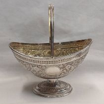 VICTORIAN SILVER SWING HANDLED BON BON BASKET WITH GILT INTERIOR & FOLIATE EMBOSSED DECORATION BY