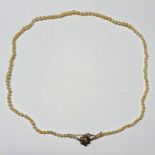 19TH CENTURY NATURAL SALTWATER GRADUATED PEARL NECKLACE WITH GOLD & DIAMOND SET FLORAL CLASP - 49CM