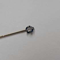 LATE 19TH OR EARLY 20TH CENTURY DIAMOND & ENAMEL STICK PIN, THE CUSHION SHAPED DIAMOND APPROX. 0.