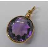 19TH CENTURY YELLOW METAL MOUNTED OVAL AMETHYST PENDANT - 3CM LONG, 4.