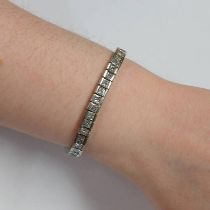 PLATINUM SET DIAMOND TENNIS BRACELET. THE 54 PRINCESS CUT CHANNEL SET DIAMONDS APPROX. 9.