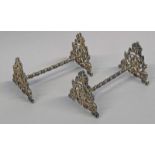 PAIR OF DECORATIVE SILVER KNIFE RESTS WITH FOLIATE ENDS BY HENRY WILLIAMSON,