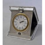 SILVER ENGINE TURNED TRAVELLING CLOCK WITH RAISED FOLIATE BORDER BY WILLIAM BASE & SONS,